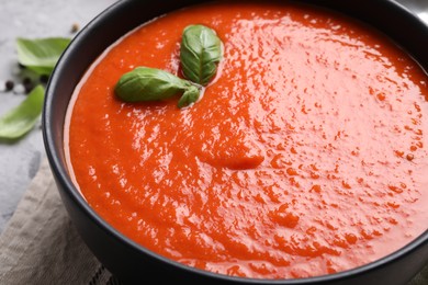 Photo of Delicious tomato cream soup on grey table, closeup