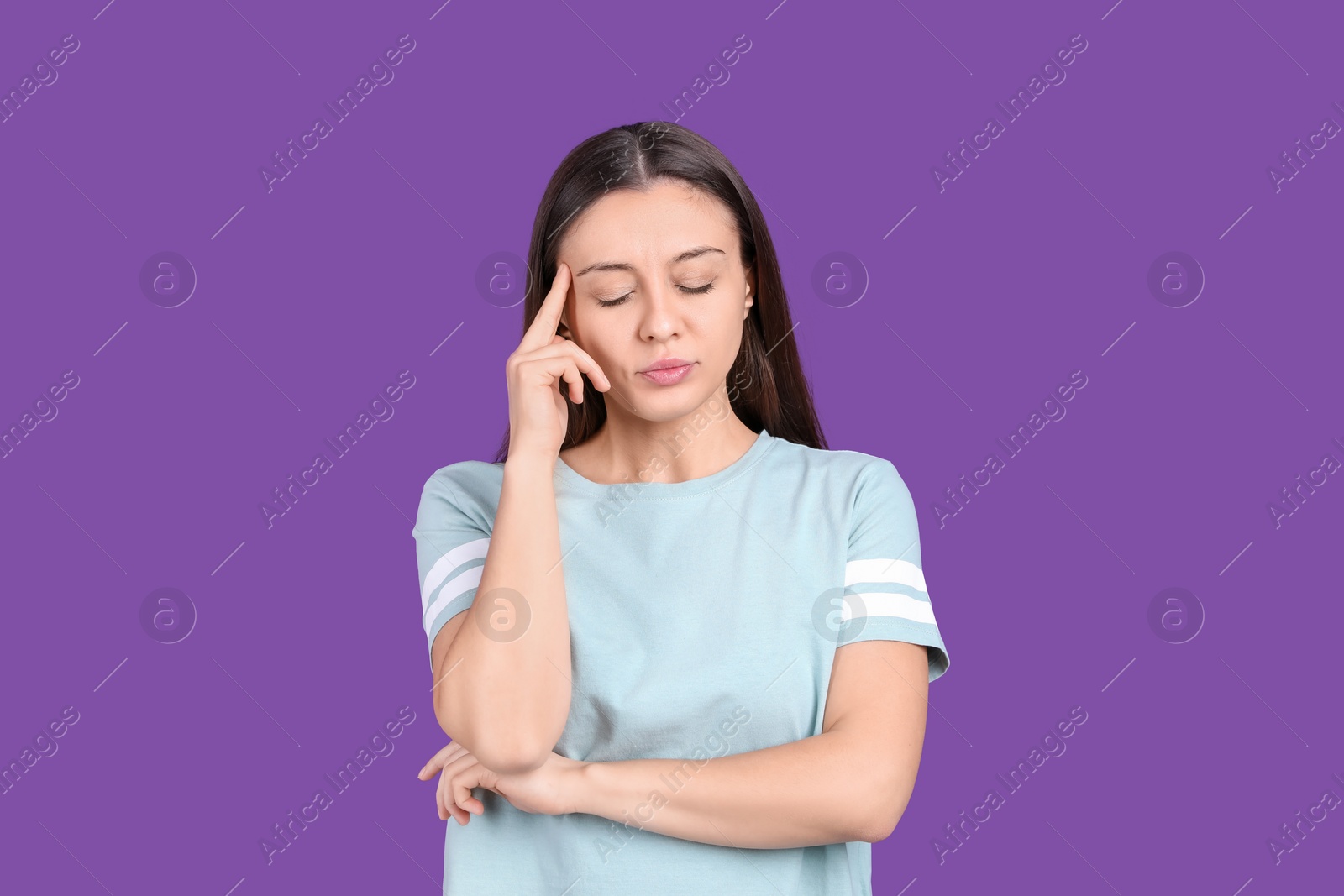 Photo of Portrait of stressed young woman on purple background