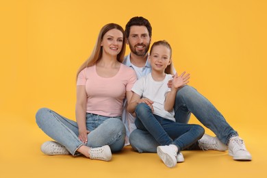 Photo of Portrait of happy family on orange background