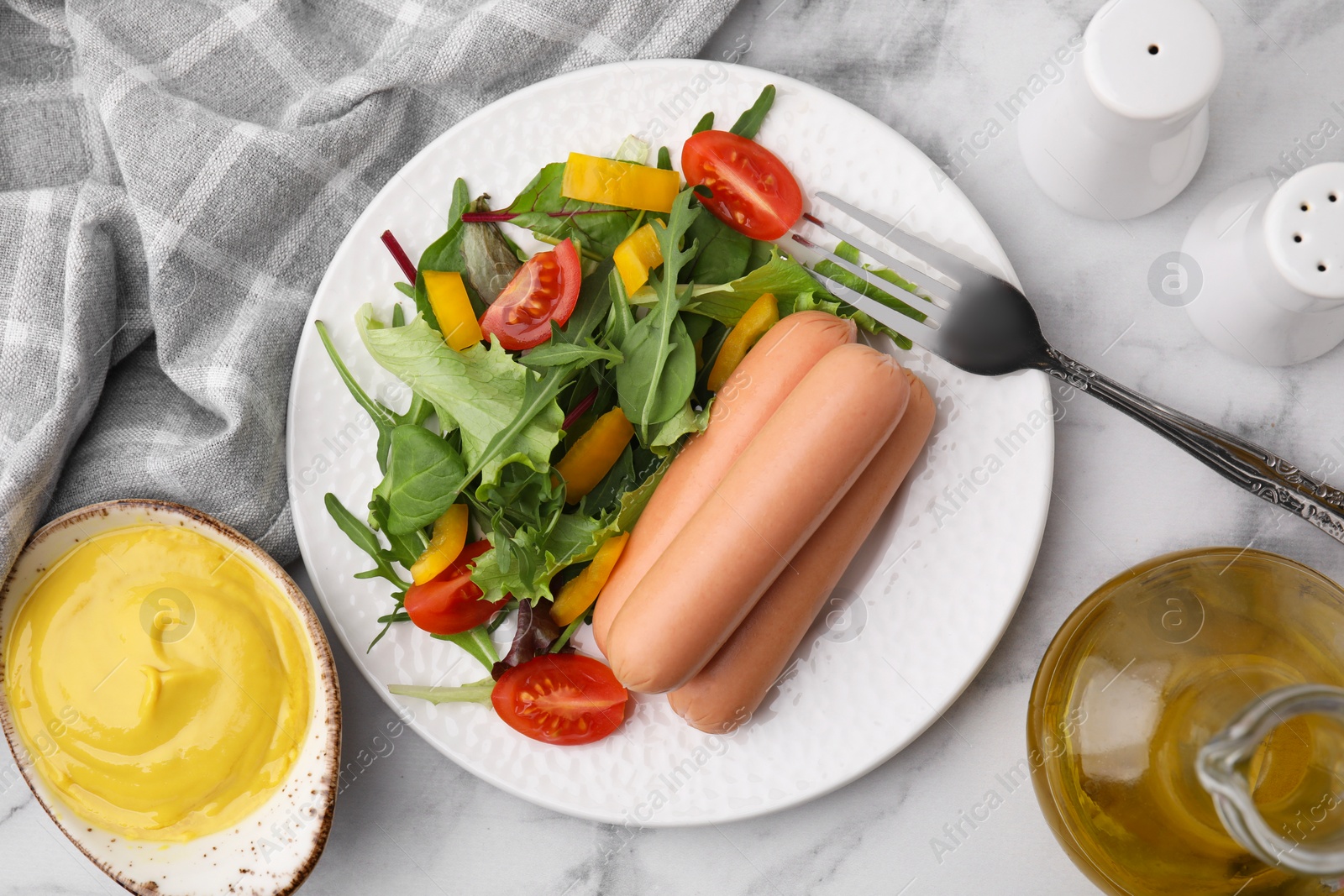 Photo of Delicious boiled sausages with salad served on white marble table, flat lay