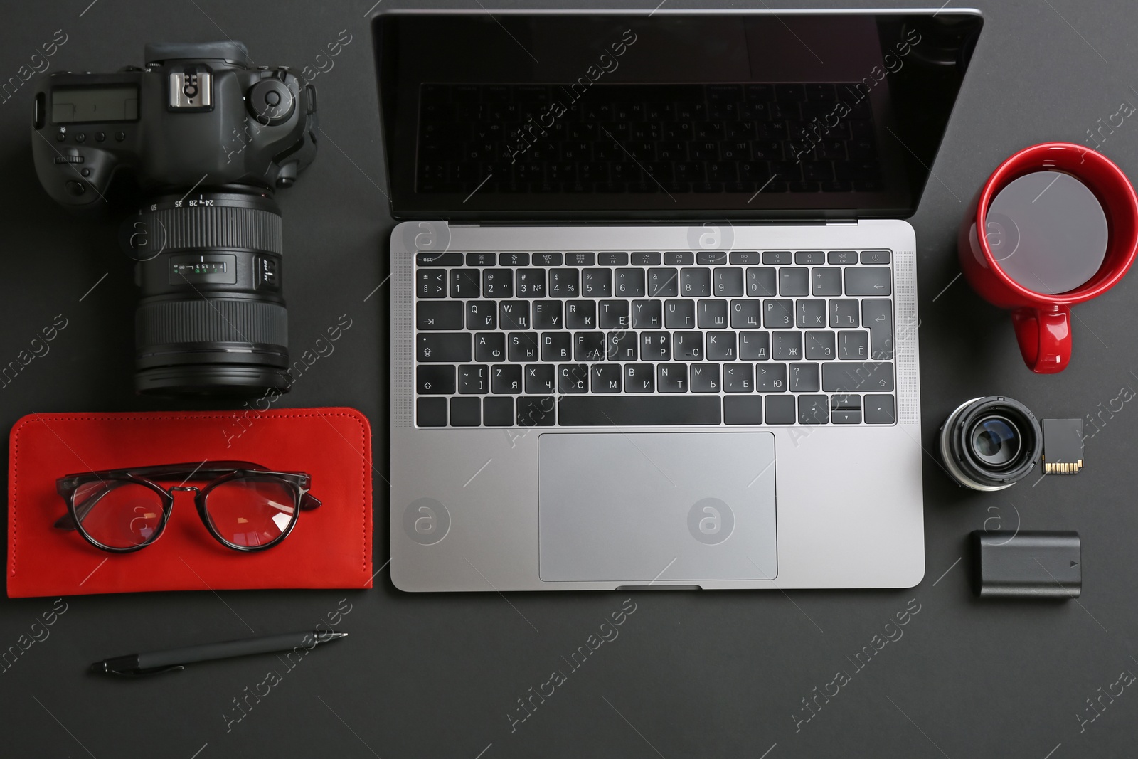 Photo of Photographer's workplace with laptop and camera on table, top view