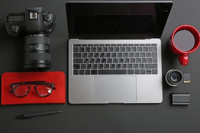 Photo of Photographer's workplace with laptop and camera on table, top view