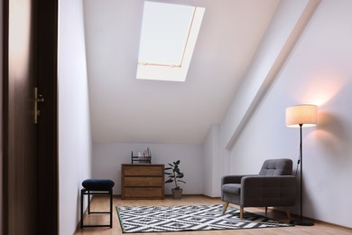 Photo of Attic room interior with slanted ceiling and furniture