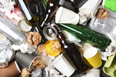 Photo of Pile of different garbage as background, top view. Recycling problem