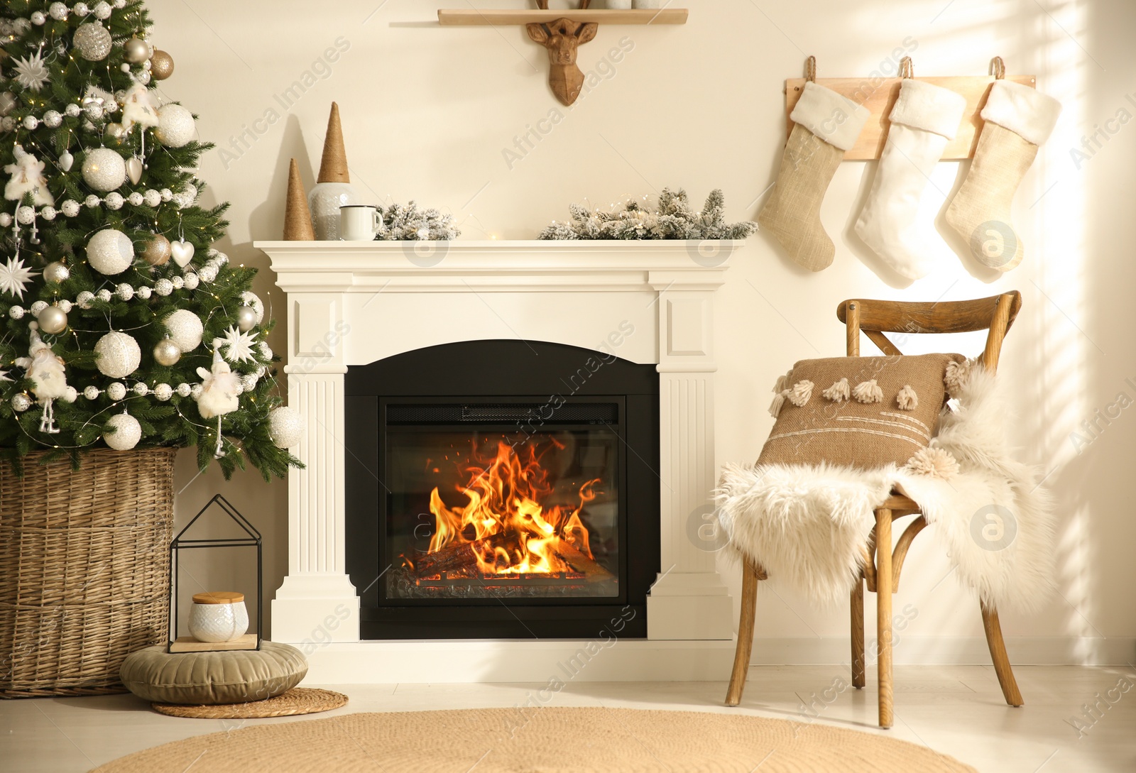 Photo of Beautiful living room interior with decorated Christmas tree and modern fireplace