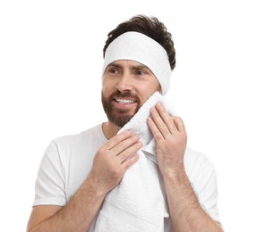 Washing face. Man with headband and towel on white background