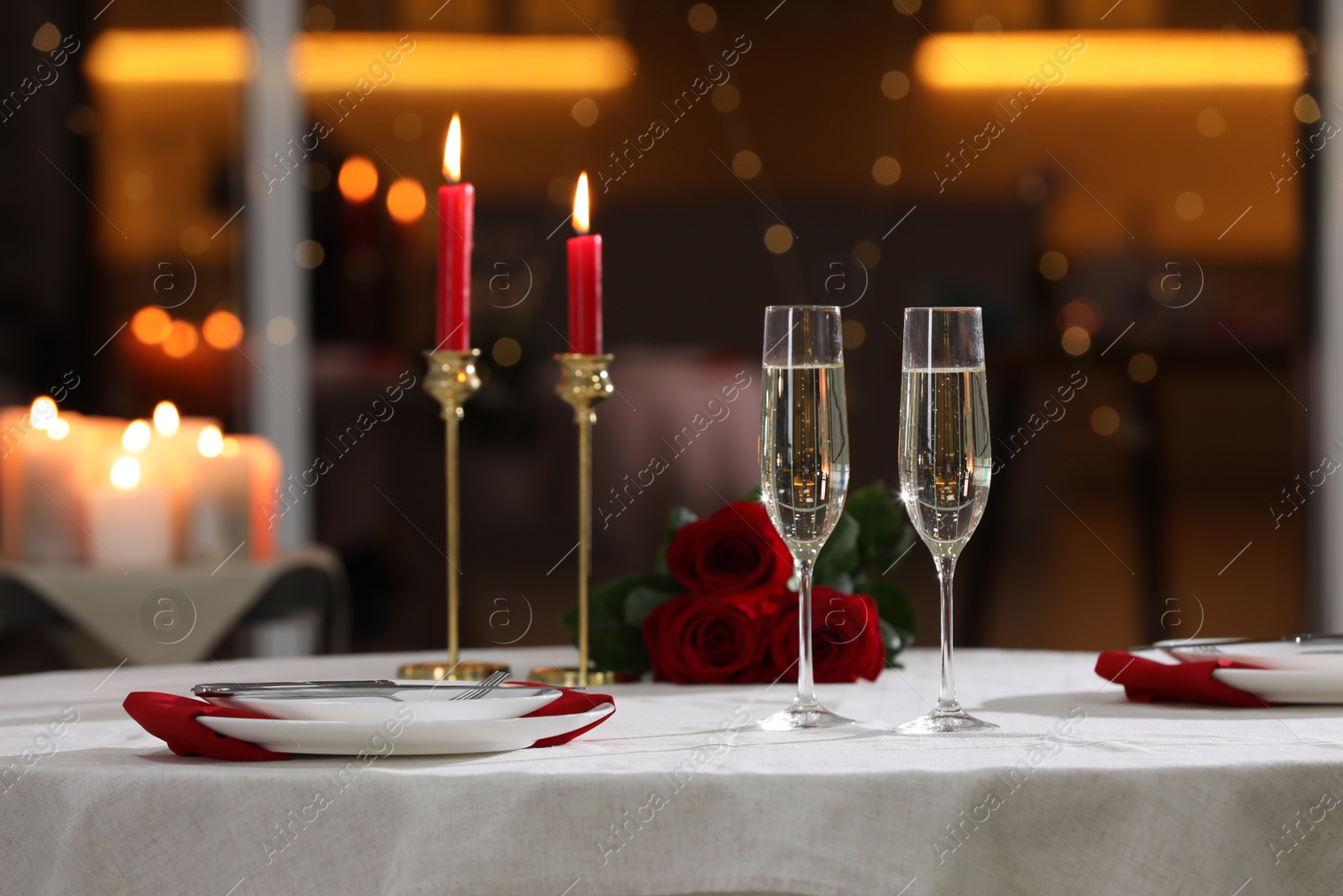 Photo of Romantic dinner table setting with glasses of champagne in restaurant