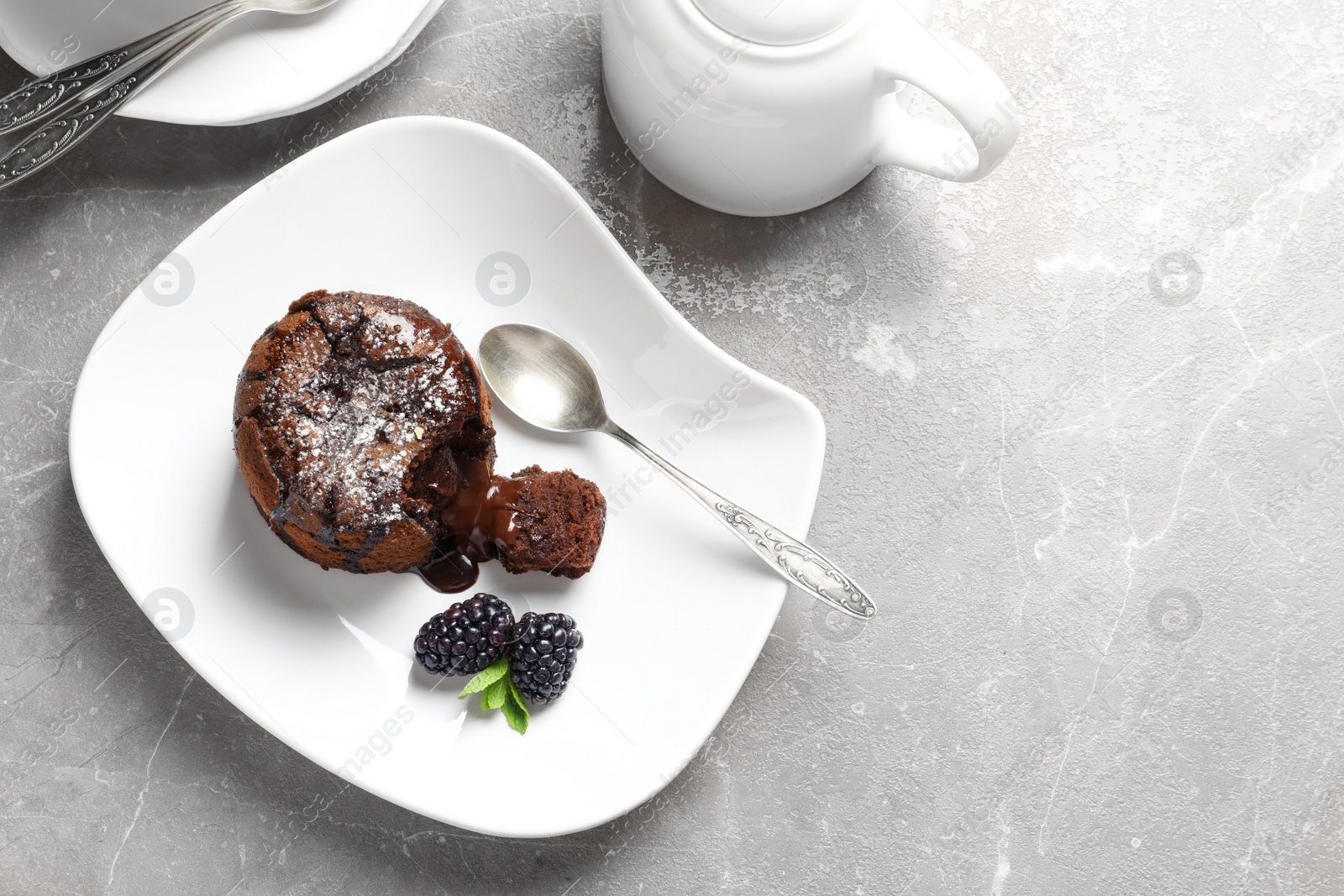 Photo of Plate of delicious fresh fondant with hot chocolate and blackberries on table, top view. Lava cake recipe