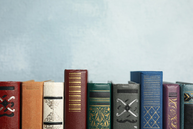 Photo of Collection of old books on light blue background. Space for text