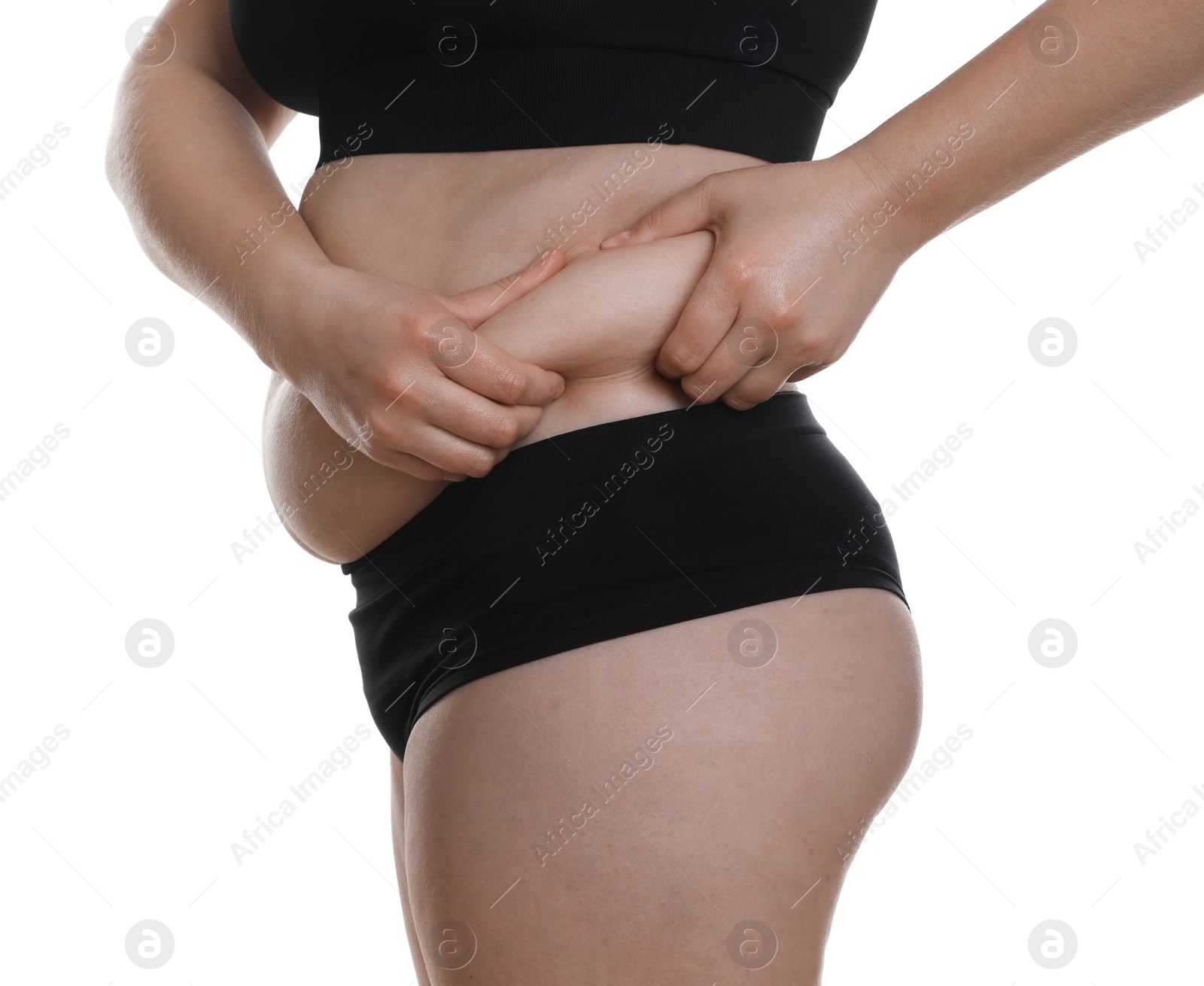 Photo of Woman touching belly fat on white background, closeup. Overweight problem