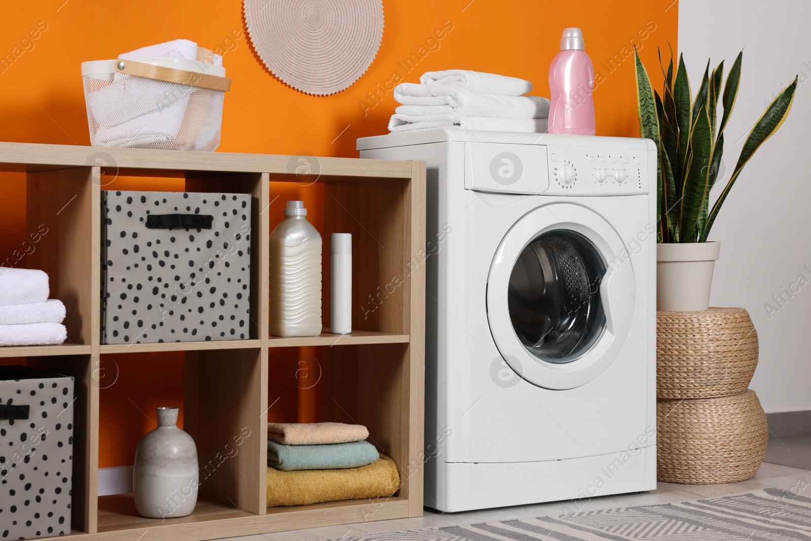 Photo of Stylish laundry room with washing machine. Interior design