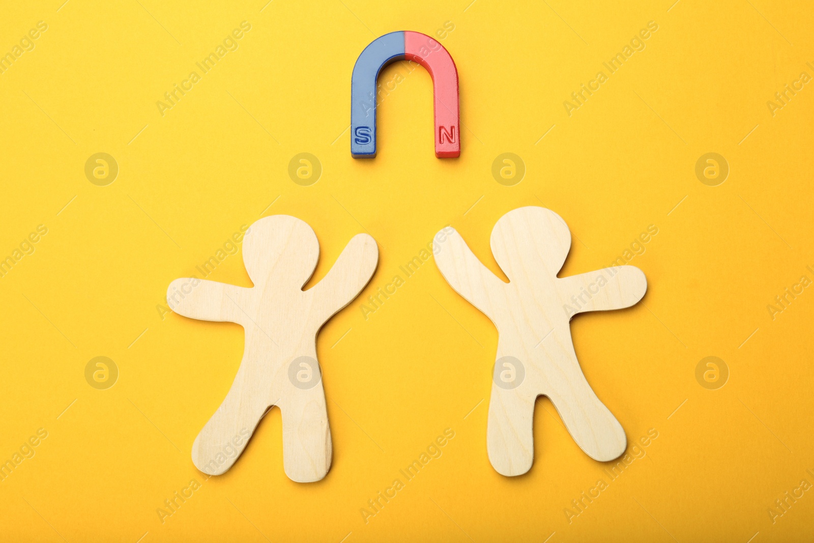 Photo of Magnet attracting people traffic on color background, top view. Marketing concept