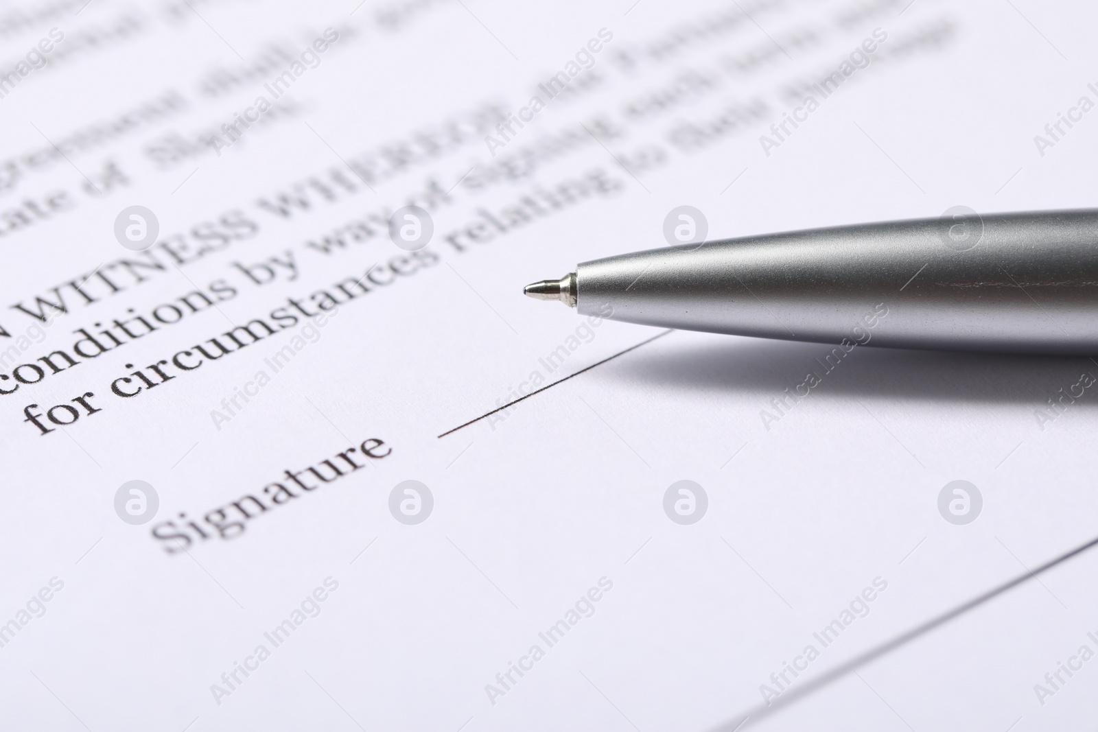 Photo of Marriage contract and pen on table, closeup