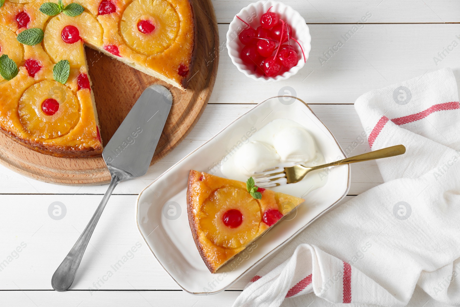 Photo of Delicious cut pineapple pie served with ice cream on white wooden table, flat lay