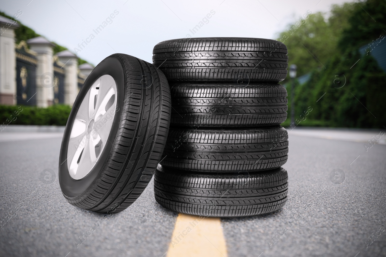 Image of Black car tires on asphalt road outdoors