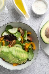 Photo of Healthy dish high in vegetable fats on light textured table, flat lay