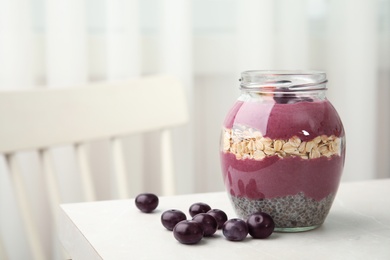 Jar of tasty acai smoothie on light table