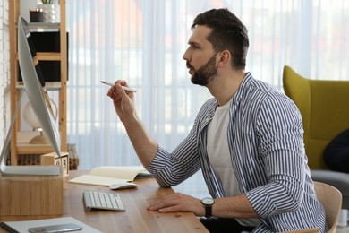 Online test. Man studying with computer at home