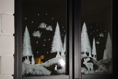 Photo of Beautiful drawing made with artificial snow on window. Christmas decor