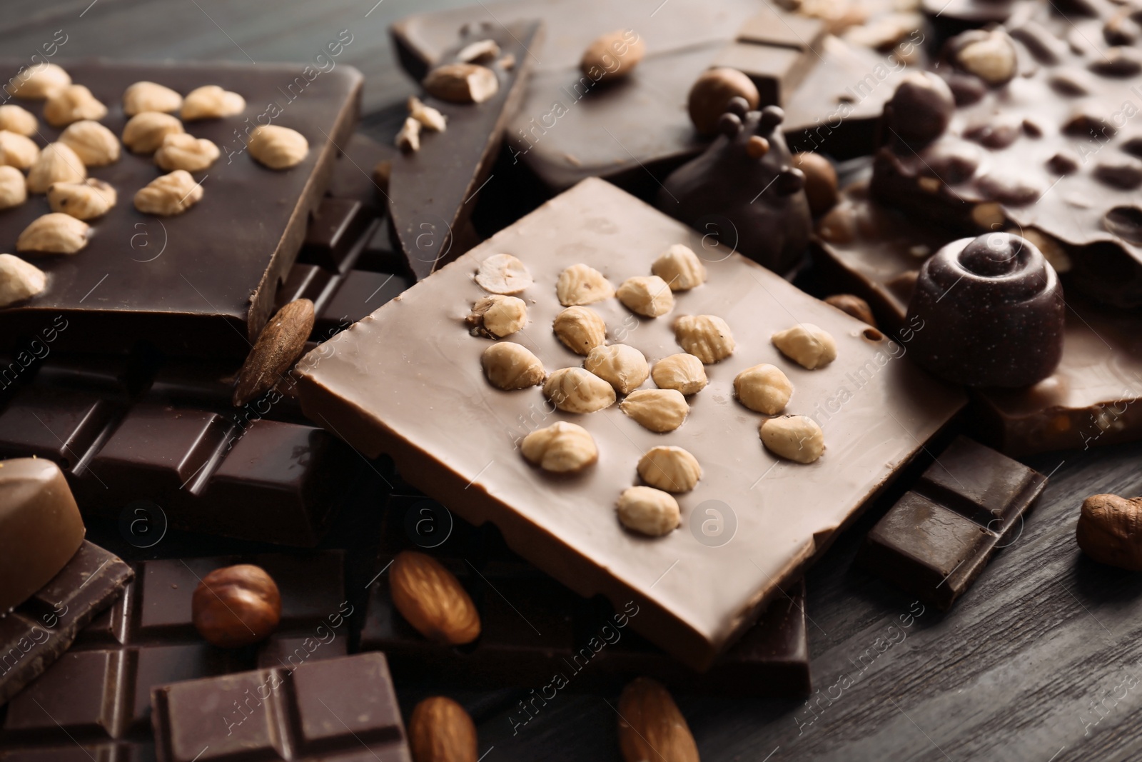 Photo of Different delicious chocolate bars and candies, closeup