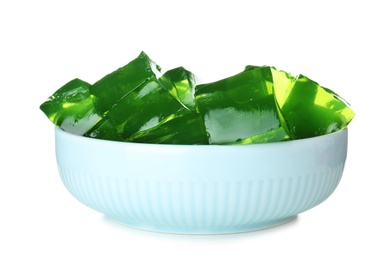 Photo of Bowl with green jelly cubes on white background