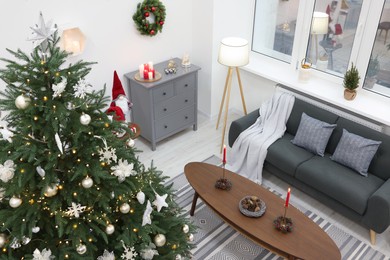 Photo of Beautiful Christmas tree and stylish furniture in cozy room, above view. Interior design