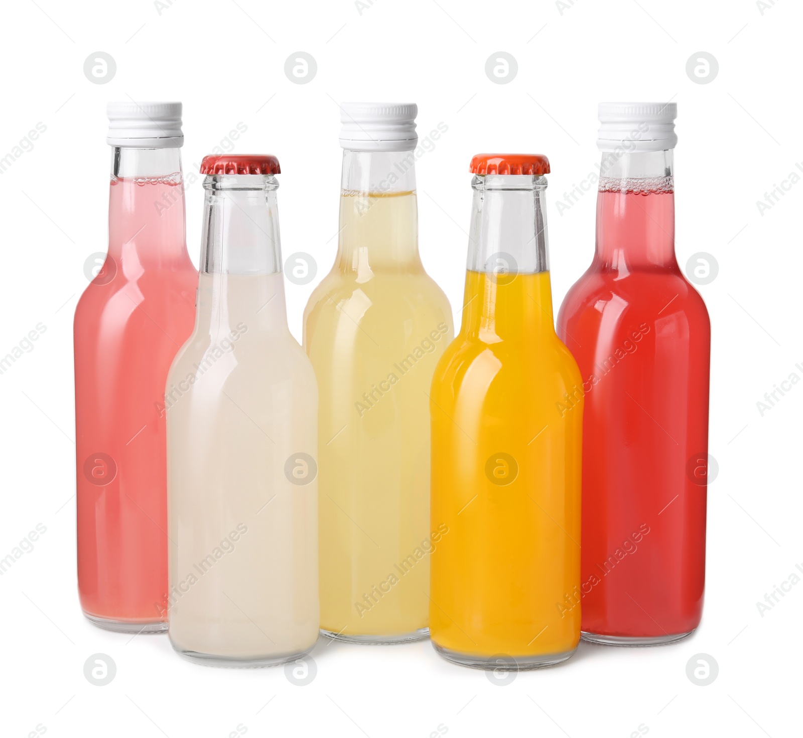 Photo of Delicious kombucha in glass bottles isolated on white