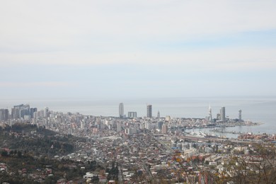 Picturesque view of city and sea under sky