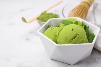 Tasty matcha ice cream in bowl on white table, closeup. Space for text