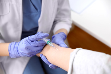 Photo of Little girl receiving chickenpox vaccination in clinic, closeup. Varicella virus prevention