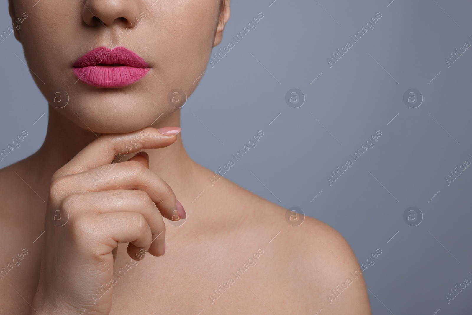 Photo of Closeup view of woman with beautiful full lips on grey background. Space for text