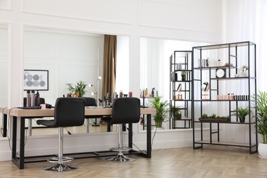 Photo of Stylish beauty salon interior with hairdresser's workplace