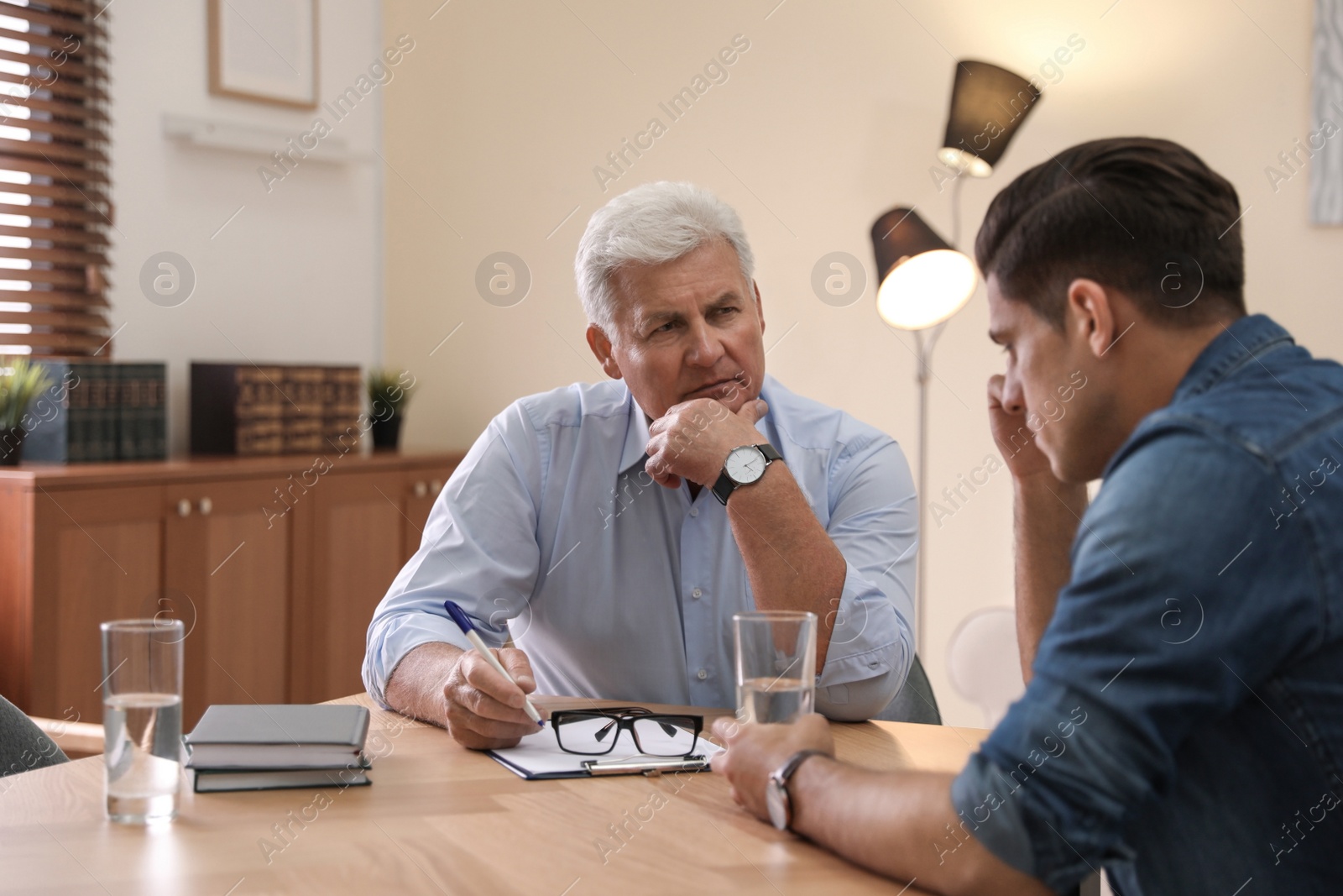 Photo of Professional psychotherapist working with patient in office