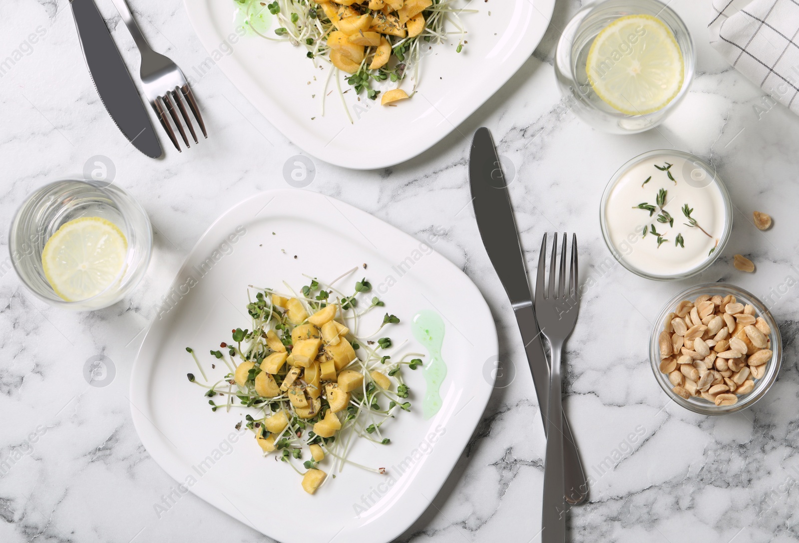 Photo of Delicious fresh carrot salads served on white marble table, flat lay