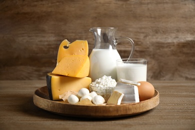 Different delicious dairy products on wooden table