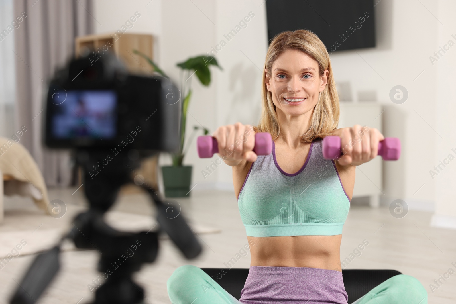 Photo of Fitness trainer recording online classes at home