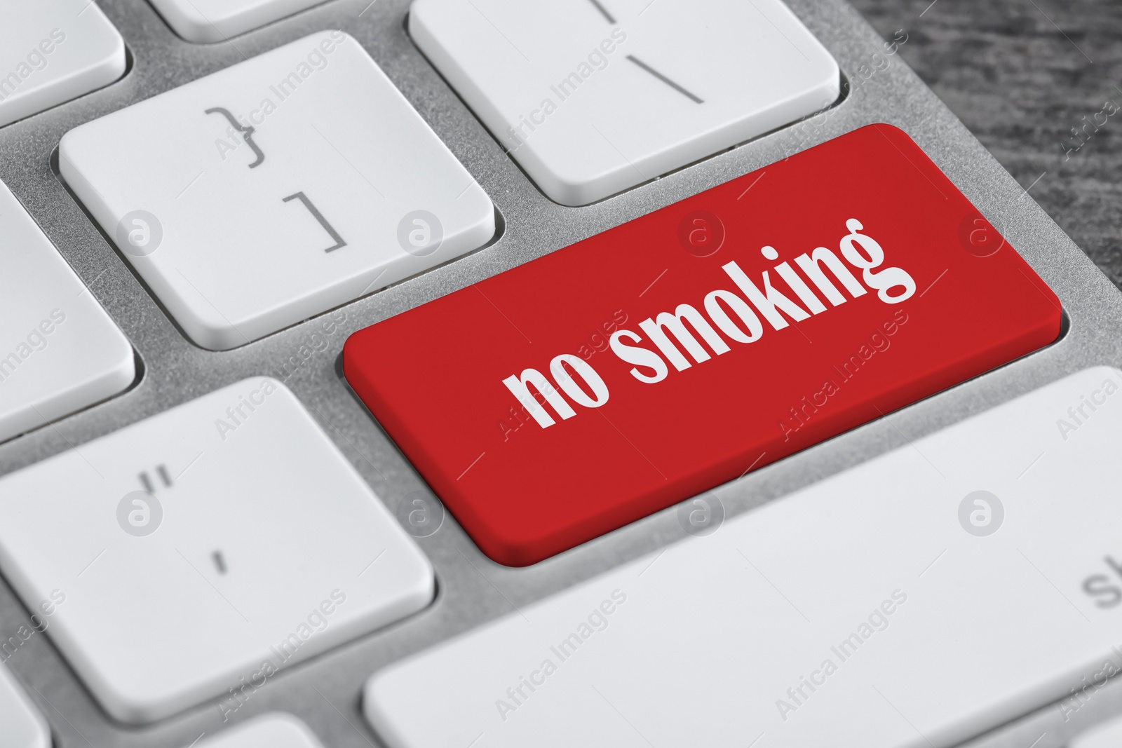 Image of Red button with phrase No smoking on computer keyboard, closeup