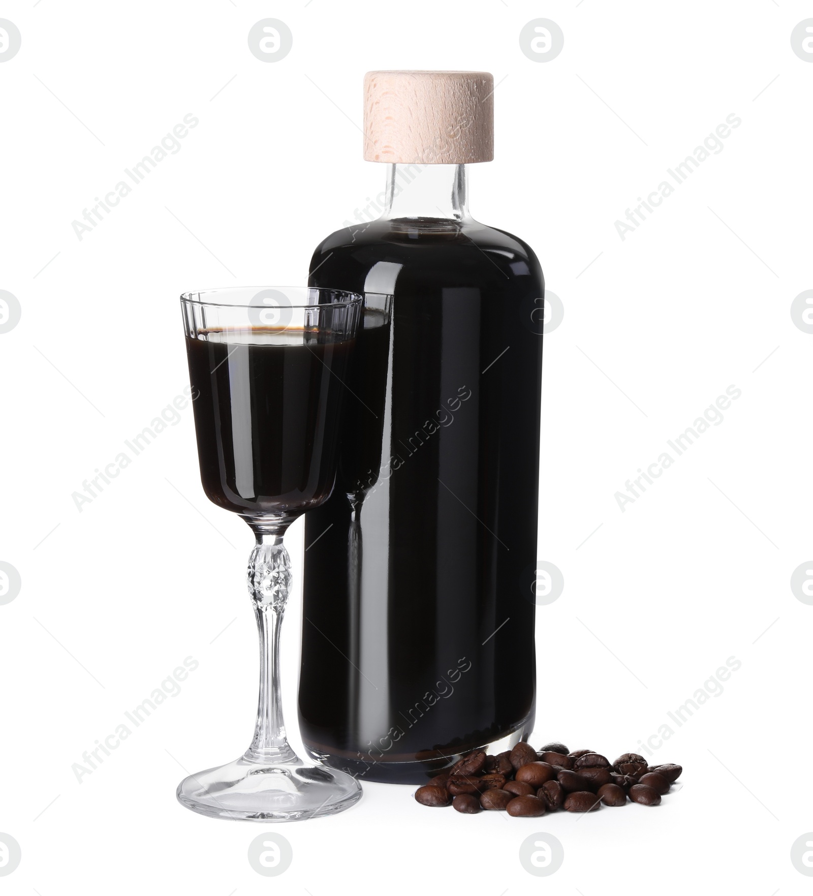 Photo of Glassware with coffee liqueur and beans isolated on white