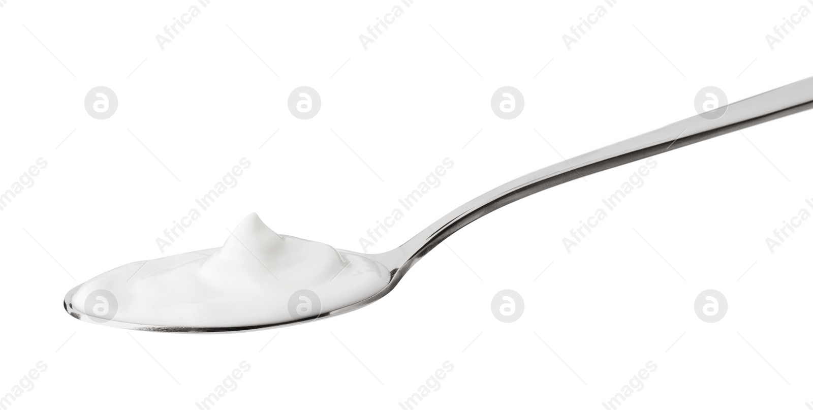 Photo of One silver spoon with sour cream isolated on white