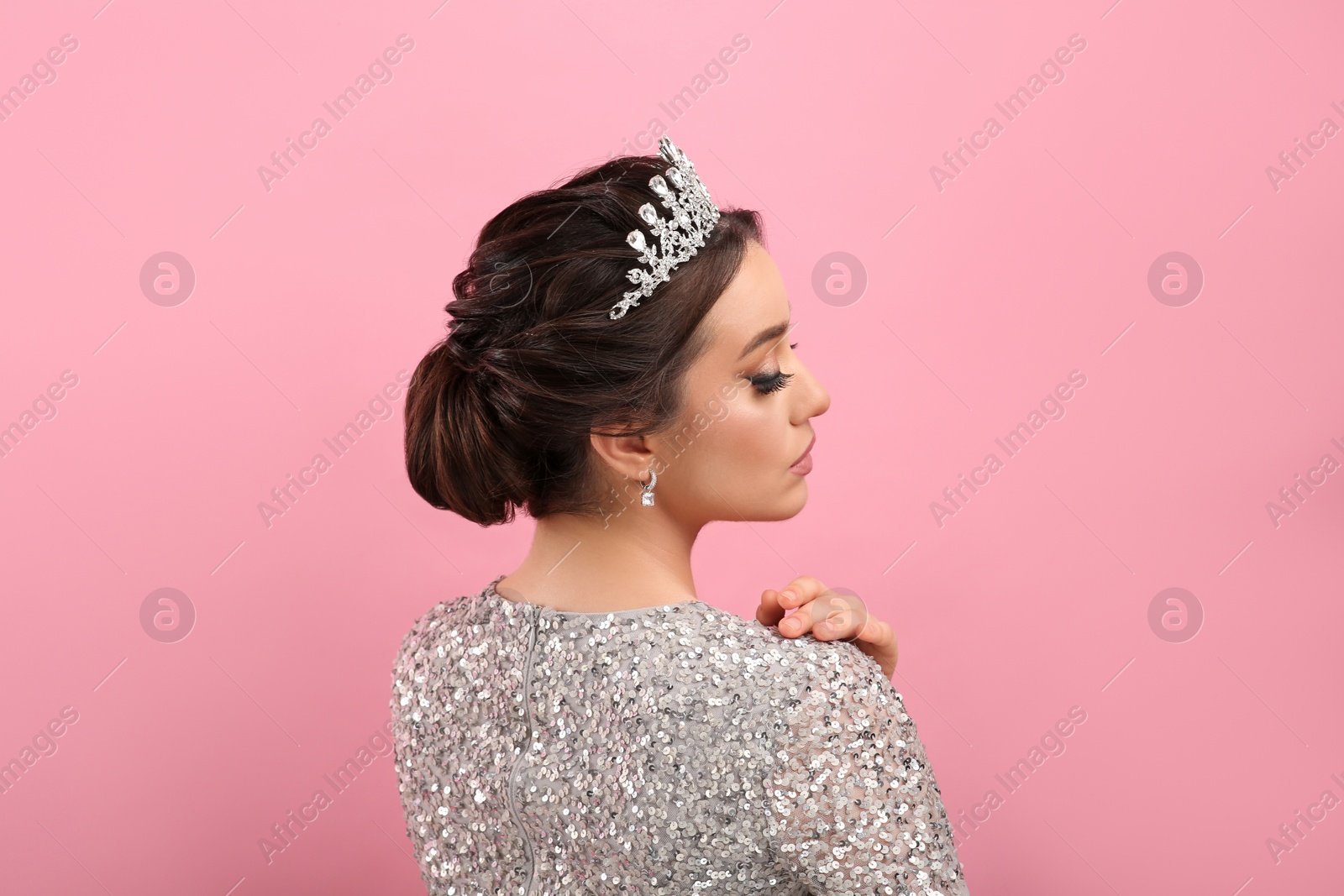 Photo of Beautiful young woman wearing luxurious tiara on pink background