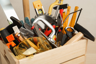 Photo of Crate with different carpenter's tools, closeup view
