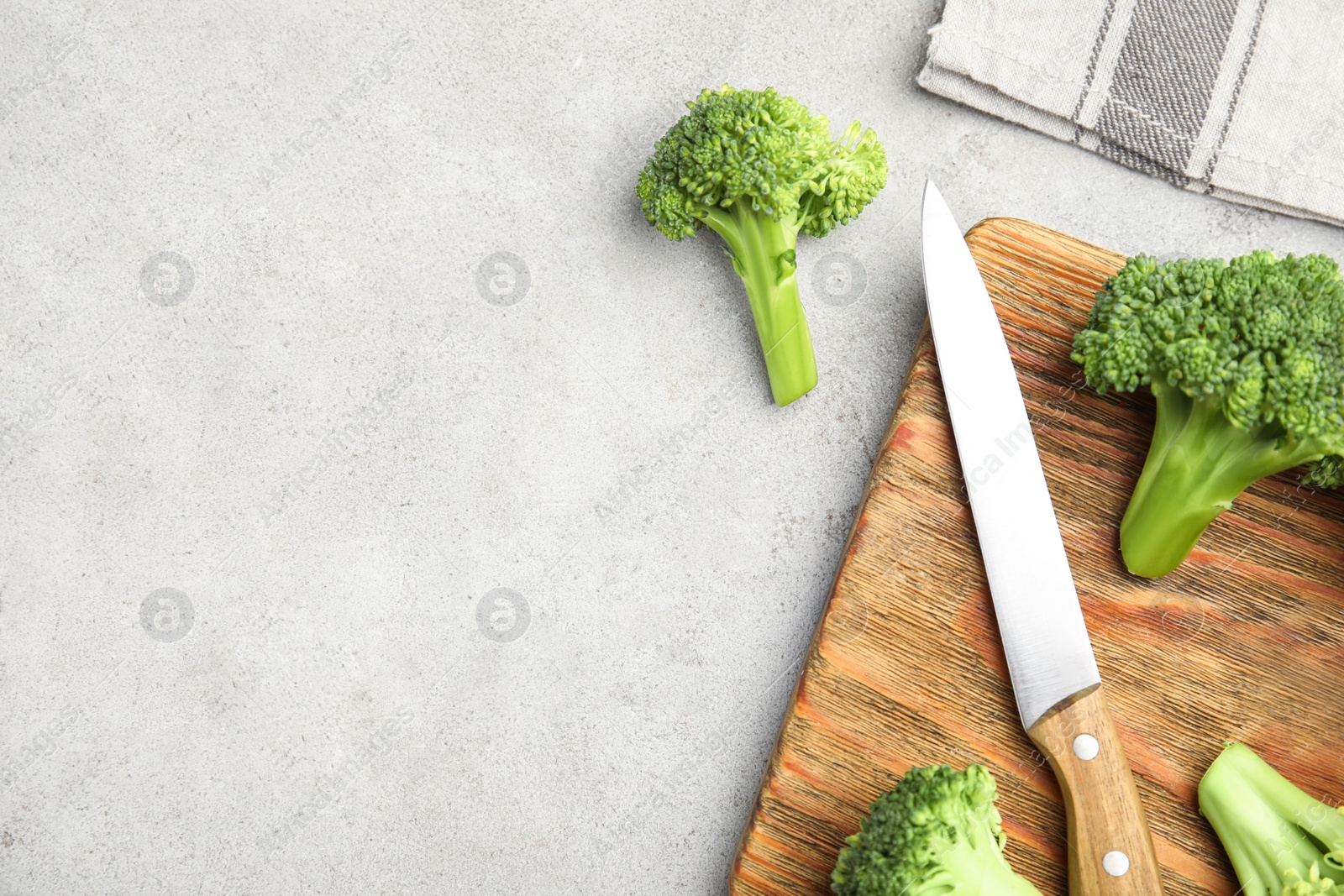 Photo of Fresh green broccoli on light table, flat lay. Space for text