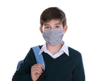Boy wearing protective mask and backpack on white background. Child safety
