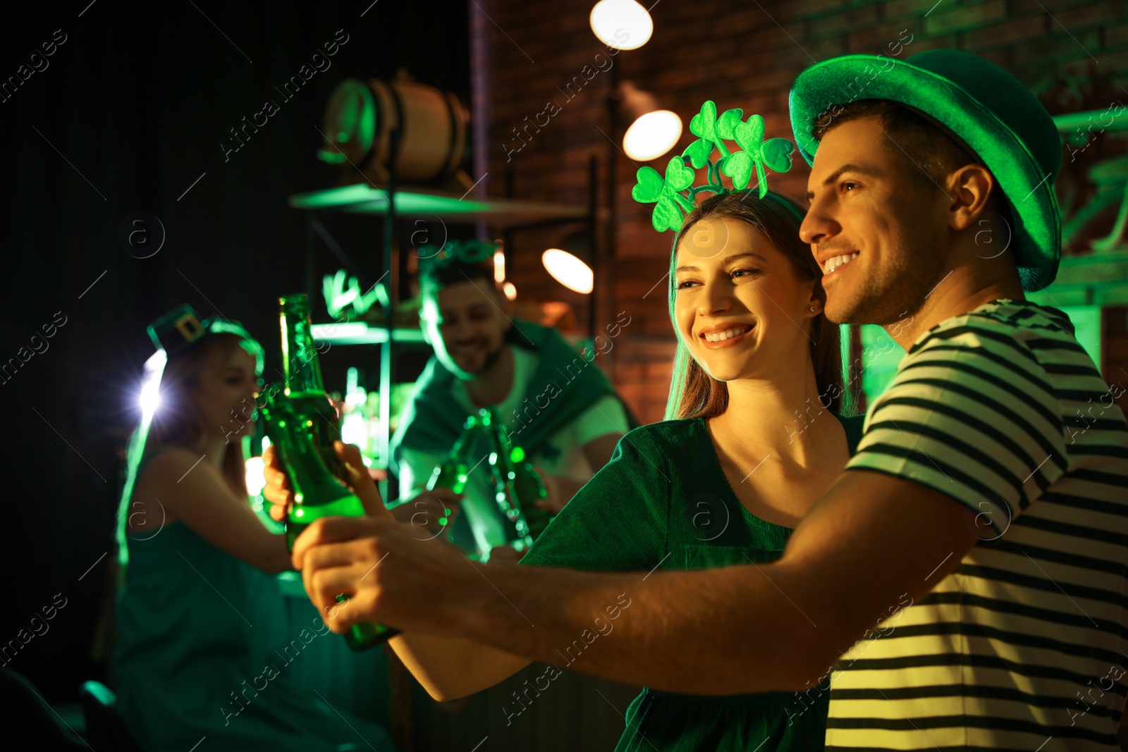 Photo of Couple with beer celebrating St Patrick's day in pub