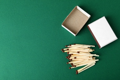 Photo of Flat lay composition with matches and space for text on color background