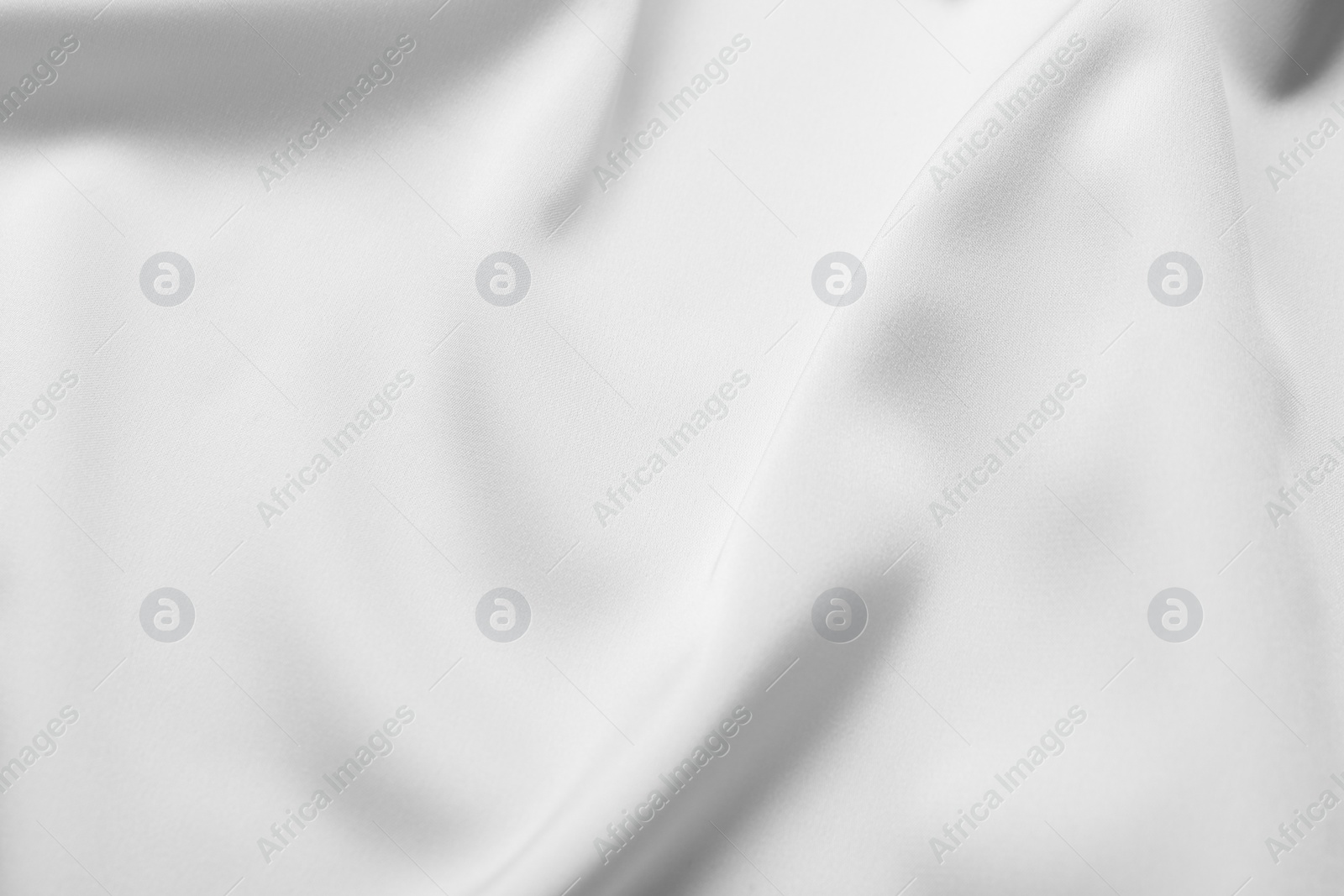 Photo of Texture of white silk ripple fabric as background, top view