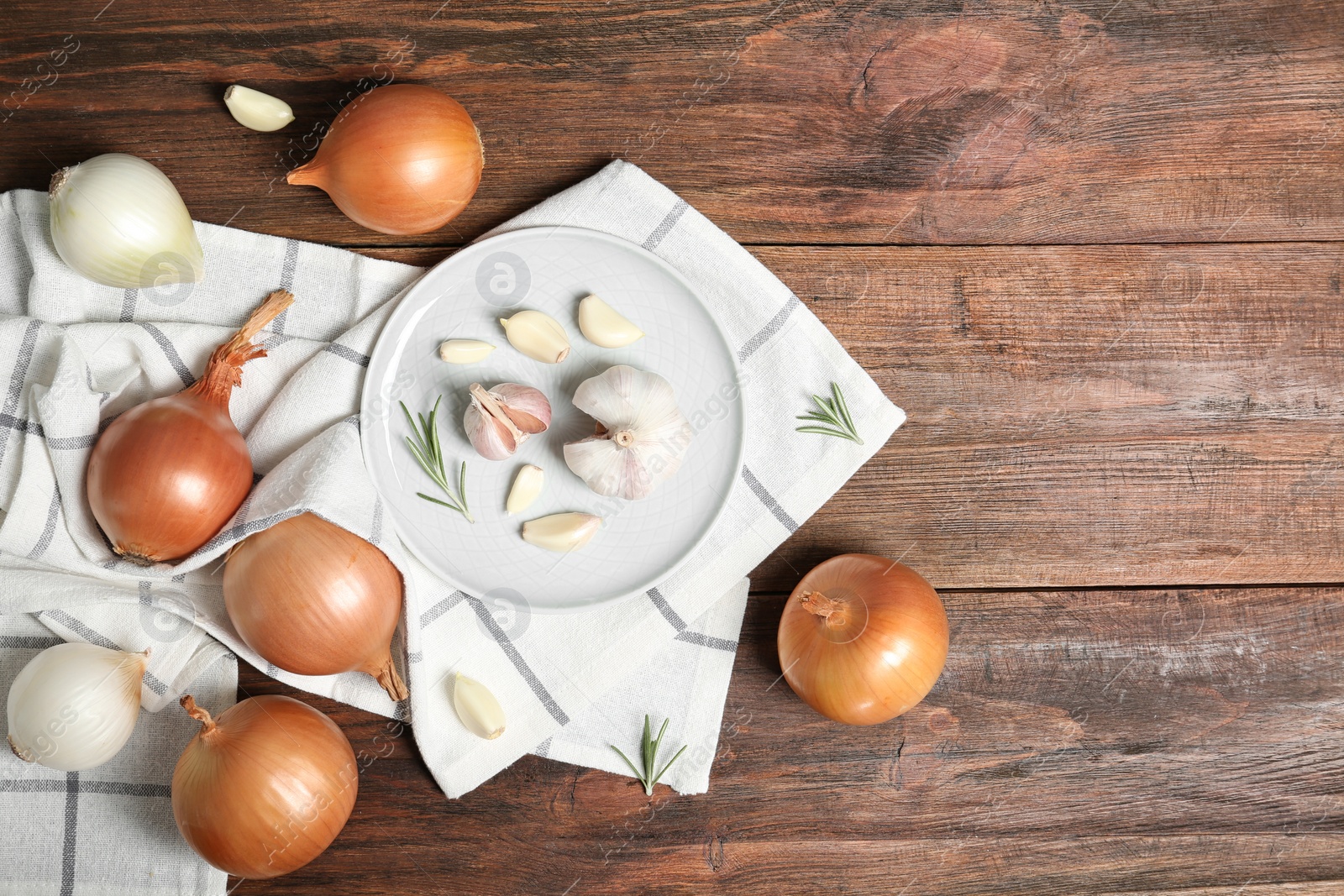 Photo of Flat lay composition with garlic, onion and space for text on table