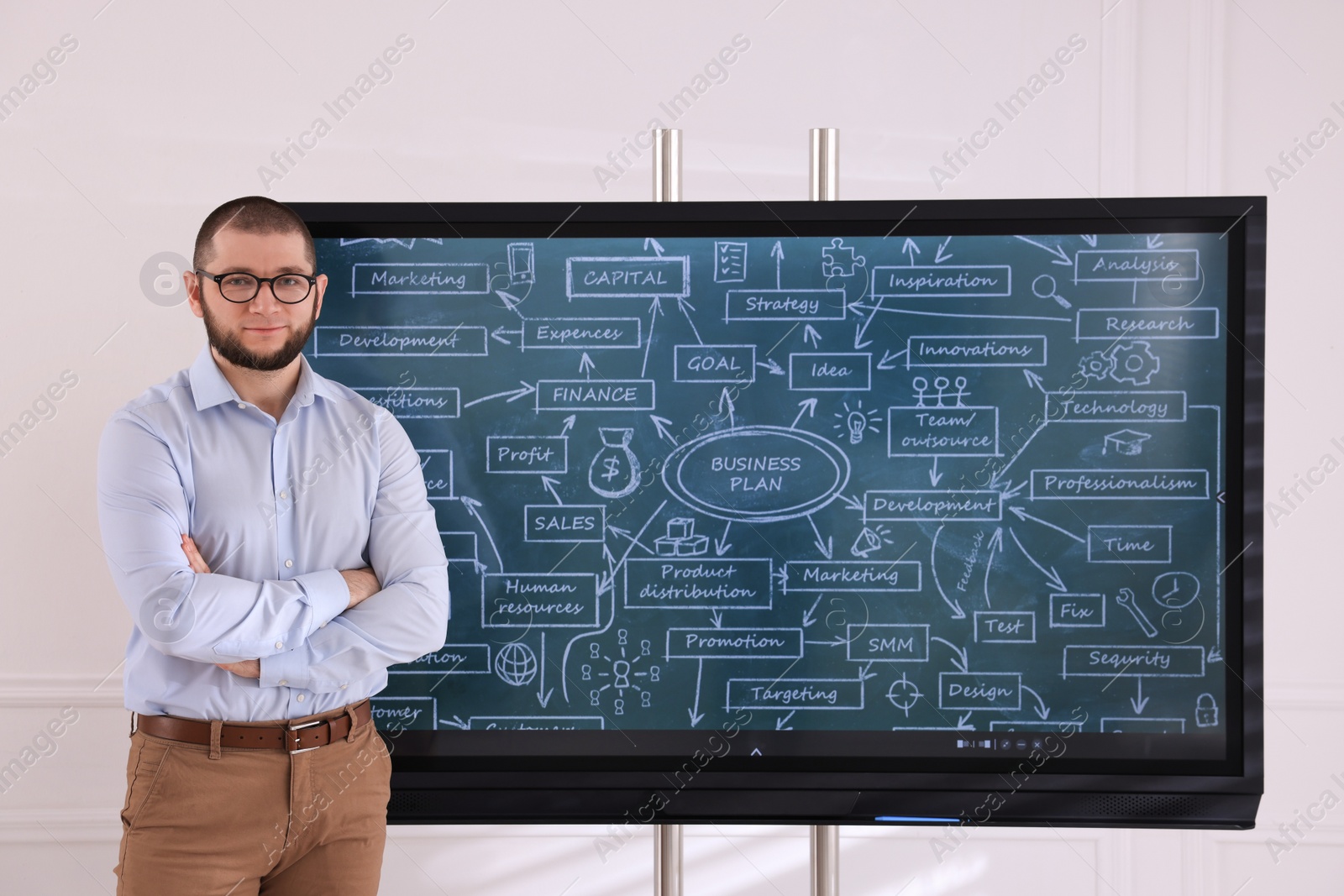 Photo of Business trainer near interactive board in meeting room