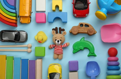 Photo of Different children's toys on light blue background, flat lay