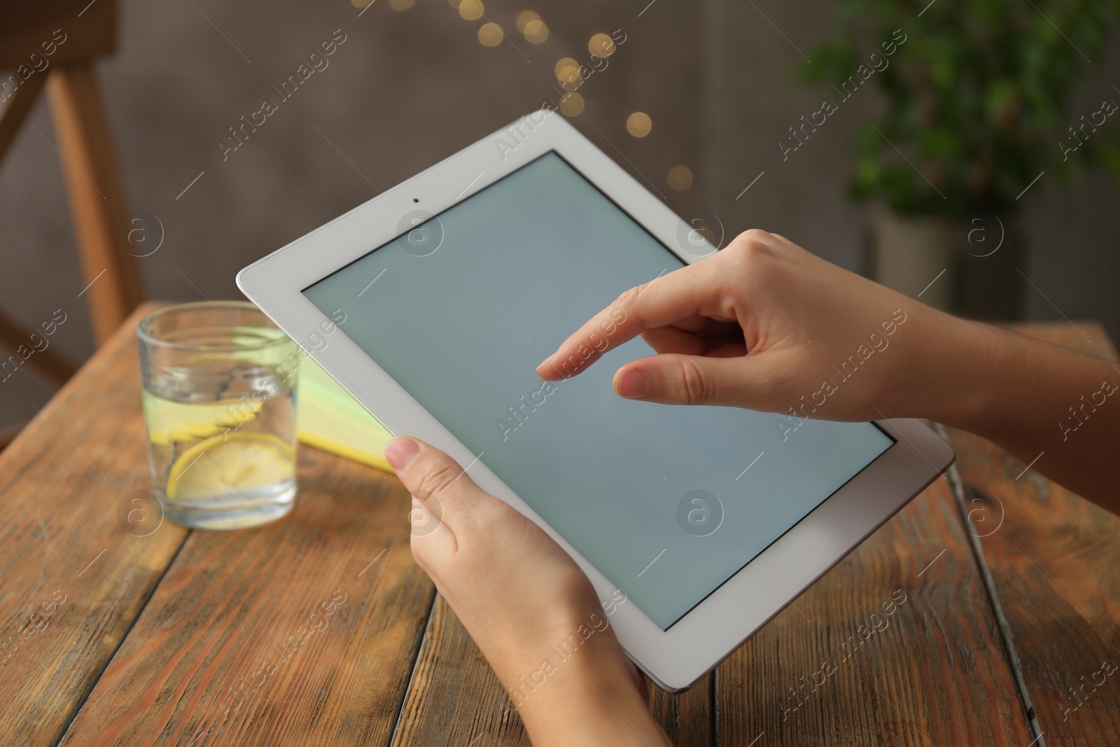 Photo of Woman using new modern tablet indoors, closeup